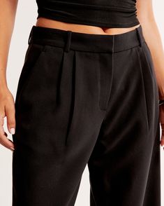 Elevate your wardrobe with the Abercrombie & Fitch Women's Curve Love Sloane Low Rise Tailored Wide Leg Pant in sleek black. Designed specifically for those who desire both style and comfort, these pants are a perfect blend of functionality and fashion.

- **Size**: 32 LONG
- **Color**: Black
- **Material**: Polyester, Viscose, Elastane
- **Gender**: Female
- **Fit**: Curve Love, tailored with additional room through the hip and thigh

These pants feature a low-rise, wide-leg silhouette with fig Classic Fitted Tapered Pants, Fitted Tapered Bottoms For Workwear, Fitted Tapered Workwear Pants, Tailored Tapered Bottoms For Workwear, Relaxed Fit Tapered Bottoms For Business Casual, Business Casual Bottoms With Relaxed Tapered Fit, Classic Tapered Bottoms For Workwear, Business Casual Tapered Bottoms With Relaxed Fit, Fitted Tapered Bottoms With Welt Pockets