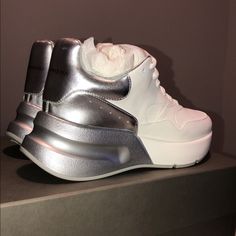 This Is A Rare Find. Oversized Runner In White Nappa Leather. This Stylish Sneaker Features Large Flat Laces With A Silver Metallic Leather Heel And Bi-Color Sole. Worn Once To An Indoor Carpeted Event. No Scratches, Scuffs Or Stains Of Any Kind. Shoes Are Practically Brand New. Comes With Original Box, Dust Bag, And An Extra Pair Of Silver Laces. No Trades Or Low Ball Offers, Please. Fits True To Size 37.5 European /7.5 Us. Shoes Alexander Mcqueen, Mcqueen Shoes, Alexander Mcqueen Shoes, Silver Lace, Metallic Leather, Stylish Sneakers, Nappa Leather, Leather Heels, Womens Shoes Sneakers