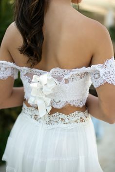 the back of a woman's white wedding dress