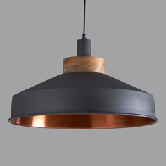 an industrial style pendant light hanging from a ceiling fixture with wood accents and metal fittings