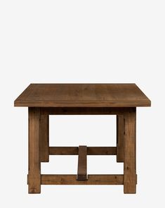 a wooden table sitting on top of a white wall