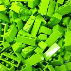 a pile of green lego blocks sitting next to each other