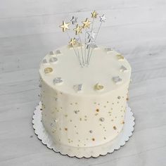 a white cake with gold stars on top