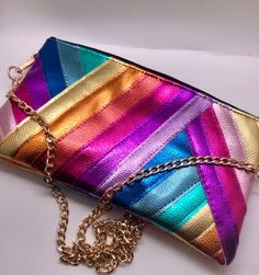 Rainbow metallic faux leather bag ❤️ Made from different colours of metallic faux leather fabric 💙 The front and back of the bag are the same as the photos in the description  💛 The size options are:  Medium is 27 by 18cms Large is 30 by 19cms 💛 Choose whether to have the bag as a clutch bag (no chain or loops) or for it to come with a detachable 120cms silver or gold chain. Just choose the option you would like from the drop down list. If you would the option to add your own strap, just sele Trendy Metallic Leather Bags, Iridescent Bag With Zipper Closure For Everyday Use, Iridescent Bags With Zipper Closure For Everyday Use, Iridescent Everyday Bags With Zipper Closure, Everyday Iridescent Bag With Zipper Closure, Rainbow Rectangular Bag For Parties, Metallic Rectangular Bags With Zipper Closure, Metallic Rectangular Bag With Zipper Closure, Rectangular Metallic Bag With Zipper Closure