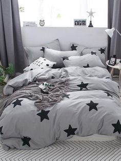 a bed with grey and black stars on it