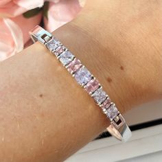 This gorgeous tennis bracelet bangle is sterling silver and lined with sparkly pink and purple cubic zirconia stones. Fully hallmarked for silver. 925. Bangle circumference: 7.25 inches. www.vintageamara.co.uk Cubic Zirconia Channel Set Tennis Bracelet As Gift, Channel Set Cubic Zirconia Tennis Bracelet As A Gift, Silver Tennis Bracelet With Channel Set As Gift, Silver Channel Set Tennis Bracelet As Gift, Pink Sterling Silver Bracelet For Anniversary, Pink Stackable Cubic Zirconia Jewelry, Pink Sterling Silver Bracelets For Anniversary, Stackable Silver Tennis Bracelet For Anniversary, Pink Tennis Bracelet As A Gift