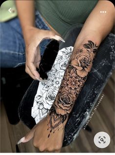 a woman is sitting on a chair with her arm tattooing roses and an ice cream cone