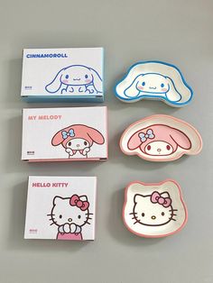 three hello kitty plates and two small boxes