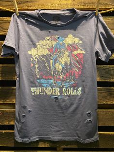 Country Deep Thunder Rolls distressed unisex T shirt available in faded black 40 Singles Jersey 100% Cotton Premium quality ringspun and compacted cotton Fine Cotton Jersey that is pigment dyed for a more vintage look Features tears and destroyed features at neck and on body Each piece is unique as this process is done by hand! 3.8 oz Made In USA Every garment dye item can be a slightly different shade in color since this is a laundry dye process. Enjoy its unique quality! SIZE CHART S M L XL 2X Distressed T Shirt, Vintage Look, Vintage Looks, Vintage Black, Unisex T Shirt, Premium Quality, Rolls, Size Chart, Dye