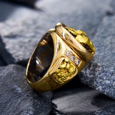 WOW! This custom made vintage mens ring is crafted of 14K yellow gold ring is centered with a 22K yellow gold nugget that is recessed into a bezel setting with traces of antiquing. The shoulders of the ring are each accented with three (3) bead set round brilliant cut diamonds and 22K yellow gold nugget inlay. The inside of the shank is rhodium plated. The ring measures 21.7mm at the top, rises 10.7mm above the finger, and tapers to 5.8mm wide by 1.4mm thick at the base of the shank. The ring is currently a size 9.75 and weights 37.4 grams. Classic Gold Nugget Ring, Classic Yellow Gold Nugget Ring, Gold Cluster Ring Collectible Fine Jewelry, Gold Cluster Ring Fine Jewelry Collectible, Heirloom Gold Nugget Ring, Gold Dome Ring With Polished Finish For Collectors, Yellow Gold Nugget Cluster Ring For Anniversary, Heirloom Style Gold Cluster Ring With Polished Finish, Gold Heirloom Cluster Ring With Polished Finish