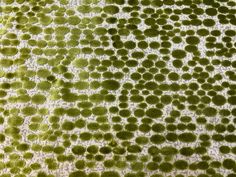 an area rug with green circles on it