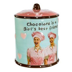 Store your cookies in retro-inspired style with this I Love Lucy Cookie Jar from Kurt Adler! Perfect for fans of I Love Lucy, this cookie jar is inspired by the chocolate factory episode and features Lucy and Ethel wearing their pink chocolate factory uniforms. The cookie jar reads, "Chocolate is a girl's best friend!". Kurt Adler | Kurt Adler I Love Lucy Cookie Jar 9.63 H x 6.25 W x 6.25 D in / redCeramic in Blue / Pink | 6.25" L x 6.25" W x 9.63" H | Wayfair | Organization Lucy And Ethel, Ceramic Cookie Jar, Pink Chocolate, Lucille Ball, Kurt Adler, Love Lucy, I Love Lucy, Chocolate Factory, Cookie Jars