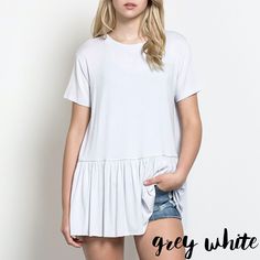 a woman in short shorts and a white t - shirt with the words grey white on it