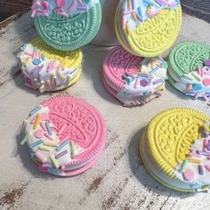 cookies decorated with icing and sprinkles on a table