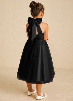 Dora features a charming A-line silhouette in matte satin and tulle, with a stylish halter neckline and playful bows. Sleeveless and easy to wear with a zipper back, it’s perfect for adding a touch of elegance to any special occasion. Party Dresses With Bow Straps And Tulle Material, Sleeveless Tulle Tutu Dress With Bow, Elegant Sleeveless Tutu Dress With Bow, Black Dress With Satin Bow For Party, Elegant Bridesmaid Tutu Dress With Bow, Elegant Black Sleeveless Tutu Dress, Sleeveless Tulle Dress With Satin Bow, Party Dress With Satin Bow And Tulle Material, Sleeveless Black Tutu Dress For Party