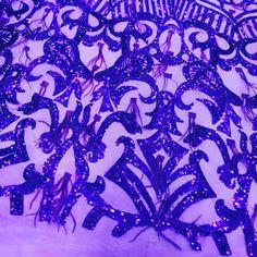 purple sequins are arranged in an intricate pattern