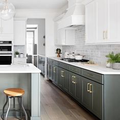 a kitchen with an island and stools in it