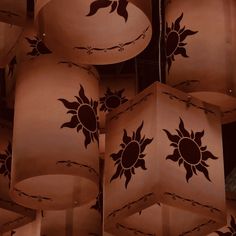 many lamps with designs on them hanging from the ceiling