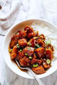 a white bowl filled with chicken and rice