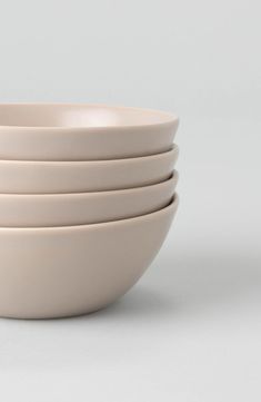 four white bowls stacked on top of each other