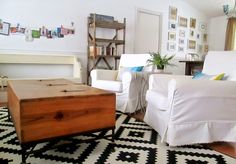 a living room with two white chairs and a coffee table