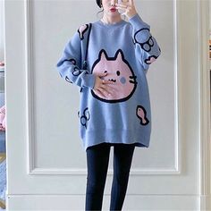 a woman wearing a blue color cute cat sweater for woman Winter Cat Print Crew Neck Sweater, Oversized Kawaii Long Sleeve Sweater, Cute Crew Neck Knit Sweater, Kawaii Knitted Long Sleeve Sweater, Kawaii Long Sleeve Knitted Sweater, Kawaii Winter Sweater With Cartoon Print, Casual Winter Sweater With Cat Print, Casual Cat Print Sweater For Winter, Cute Knitted Acrylic Tops