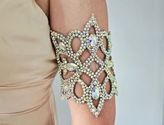 Upper arm bracelet with AB rhinestones for belly dance and ballroom dance performances.  The bracelet has adjustable webbing and a silicone strap which creates a perfect fit on the upper arm, it doesn't give any chance for the bracelet to slide down. The size of the arm bracelet is 8.5-13 inches (22-34cm). If you have another measurement please add it in the comments to the order. The width of the bracelet in its widest part is 6 1/2 inches (16.5 cm). Other bracelets: http://bit.ly/3gOBqnf Bangl Party Cuff Bracelet With Crystal Bling, Adjustable Glamorous Party Cuff Bracelet, Adjustable Glamorous Cuff Bracelet For Parties, Glamorous Adjustable Cuff Bracelet For Party, Party Crystal Chain Bracelet, Adjustable Rhinestone Bracelets For Evening, Party Crystal Bracelet With Rhinestones, Adjustable Jeweled Bracelets For Party, Adjustable Rhinestone Crystal Bracelet For Evening