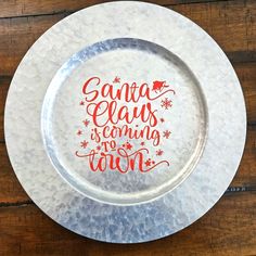 a glass plate that says santa claus is coming to town