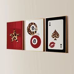 three framed art pieces depicting different types of playing cards on the wall, each with a leopard print