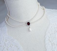 Vintage Romantic Style Red Garnet CZ Necklace, Wedding Pearl and Garnet CZ Bridal Choker,  Multi Row Vintage Swarovski Pearl Necklace Materials used: - White/Ivory Cream Swarovski pearls - cubic zirconia stones - rhodium plated over brass metal findings The necklace will arrive packaged ready for gift giving in a delicate white jewelry box with a silver ribbon. Matching earrings for this necklace:  Back to my shop http://www.etsy.com/shop/crinadesign73 Thank you for visiting my store! Elegant Red Pearl Necklace For Formal Occasions, Elegant Red Pearl Necklace For Weddings, Elegant Red Bridal Necklace With Polished Beads, Red Elegant Jewelry With Pearl Pendant, Festive Red Elegant Pearl Necklace, Elegant Red Pearl Necklace With Natural Stones, Pearl And Garnet Necklace, Vintage Pearl Necklace, Swarovski Pearl Necklace