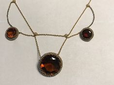 "A late victorian or Edwardian(circa 1890-1915), 18k(750 stamped on spring ring), yellow gold large fancy bezel set Madera Citrines and natural pearl necklace.  Condition-no problems, bright yellow gold all seed pearls in gallery framing citrines are present and lustrous.  Delicate floral , pearl stations from which the chain swags. The center citrine is 21mm(central pendant is 26mm, two smaller citrines are 12mm.  Lenght  16\", wt. 20.4 grams.  Best deep golden/hint or orange color.  Finest qua Heirloom Rose Cut Diamond Round Necklace, Heirloom Style Rose Cut Diamond Necklace, Formal Amber Necklace In Fine Jewelry Style, Evening Yellow Gold Jewelry With Rose Cut Diamonds, Victorian Yellow Gold Cabochon Jewelry, Antique Round Jewelry With High Luster, Yellow Gold Cabochon Necklace For Wedding, Antique Round High Luster Jewelry, Antique High Luster Round Jewelry