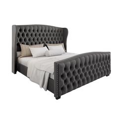 an upholstered bed with white pillows and gray linens on the headboard