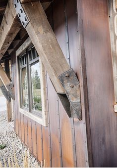 an old wooden building with a window on the side