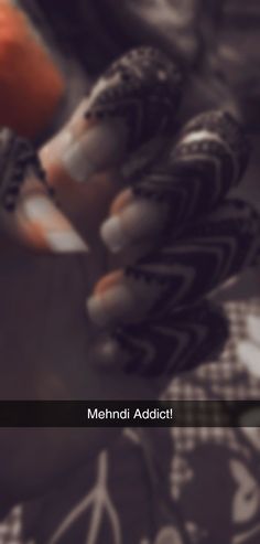 an orange and white bird sitting on top of a table next to a person's hand