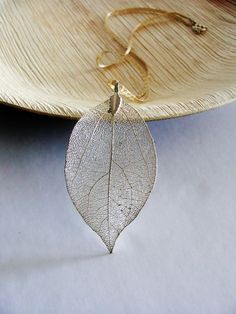 Silver leaf Necklace, Huge Silver Necklace, Organic Necklace --------- This necklace is ready to ship. --------- 🎁 ITEM DETAILS: ★Pendant This is a natural real Leaf, plated with 925 sterling silver in an electroforming process, which makes it so realistic and alive. Size: 35/55 mm or 1.4/2.2 inch. ★Necklace Solid 14k gold-filled chain with silver locker. Length : 43 centimeter/ 17.5 inch Length is adjustable. ★Metal: Sterling silver ★Metal Purity: 925 solid silver 🎁 PREPARATION : This necklace is ready to ship. You will receive it in an elegant gift box. 🎁 SHIPPING OPTIONS : ★ Free international standard shipping, registered mail 14-16 business days. OR ★EXPRESS international shipping by DHL, 3-5 days, 35$ cost. ---------------------------------------------------- 🎁 Have a custom orde Leaf Necklace Silver, Organic Necklace, Necklace Leaf, Nature Inspired Wedding, Real Leaf, Leaf Nature, Leaf Necklace, Leaf Pendant, Metal Necklaces