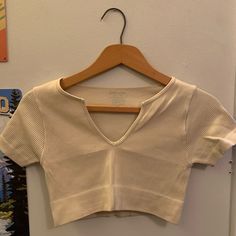 Color: Cream White Size: Xs/S Condition: Never Worn! Cropped Fit 94% Nylon, 6% Spandex Super Cute Cream Workout Top, Just Doesn’t Fit! Any Questions, Comment Below!! Thanks Fitted V-neck Crop Top For Workout, Beige Seamless V-neck Crop Top, Fitted Beige V-neck Crop Top, Fitted V-neck Workout Crop Top, Casual Beige Elastane Tops, Fitted Sporty Beige Top, Beige Stretch Crop Top For Workout, V-neck Stretch Crop Top For Workout, Fitted Beige Workout Top