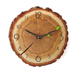 a clock made out of a tree stump with green hands and numbers on the face