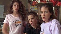 three women in pink shirts standing next to each other