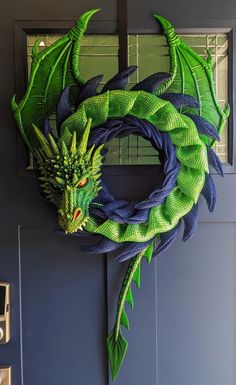 a green dragon wreath hanging on the front door