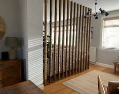 a living room filled with furniture next to a wooden wall mounted on the side of a wall