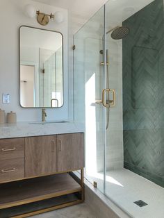 a bathroom with a sink, mirror and shower in it's center piece is shown