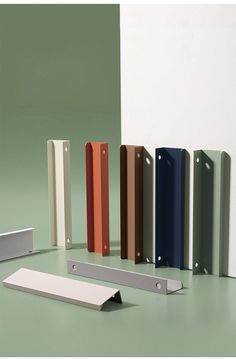 several different types of door handles on a green surface