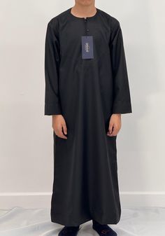 Introducing our Boys Hadi Jubba, the perfect addition to your young ones Islamic clothing collection. Made from a high-quality cotton mix fabric, this thobe is not only easy to iron but also incredibly soft and comfortable to wear. The meticulous stitching and expert embroidery make this thobe a truly stand-out piece. Available in a wide range of colours and sizes, you're sure to find the perfect fit for your personal style. We also offer this Hadi jubba in Men's sizes. Whether you're attending Casual Cotton Thobe With Long Sleeves, Casual Cotton Long-sleeved Thobe, Casual Long-sleeved Cotton Thobe, Casual Long Sleeve Cotton Thobe, Casual Cotton Thobe For Eid, Modest Black Thobe For Eid, Black Cotton Long Sleeve Kurta, Habits Musulmans, Islamic Clothing