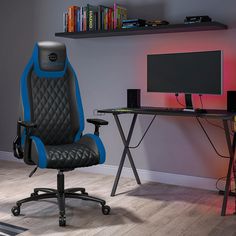 a black and blue office chair sitting in front of a desk with a computer monitor