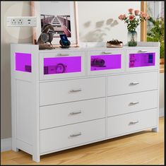 a white dresser with purple drawers in a room