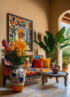 a living room filled with lots of colorful furniture and flowers in vases on the table