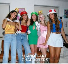 four girls dressed up in costumes posing for the camera