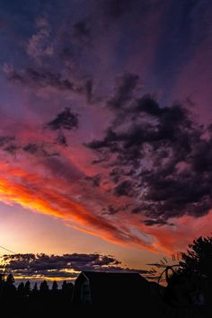 the sky is purple and orange as the sun sets