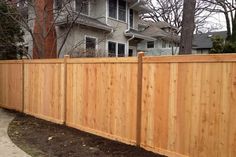 a wooden fence in front of a house