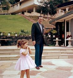 John Wayne with daughter, Aissa, circa 1960, photographed at their ranch-style home in the San Fernando Valley. Pool house is in the foreground with main residence on the hill. Ann Margaret, San Fernando Valley, John Wayne, Celebrity Houses, American Heroes